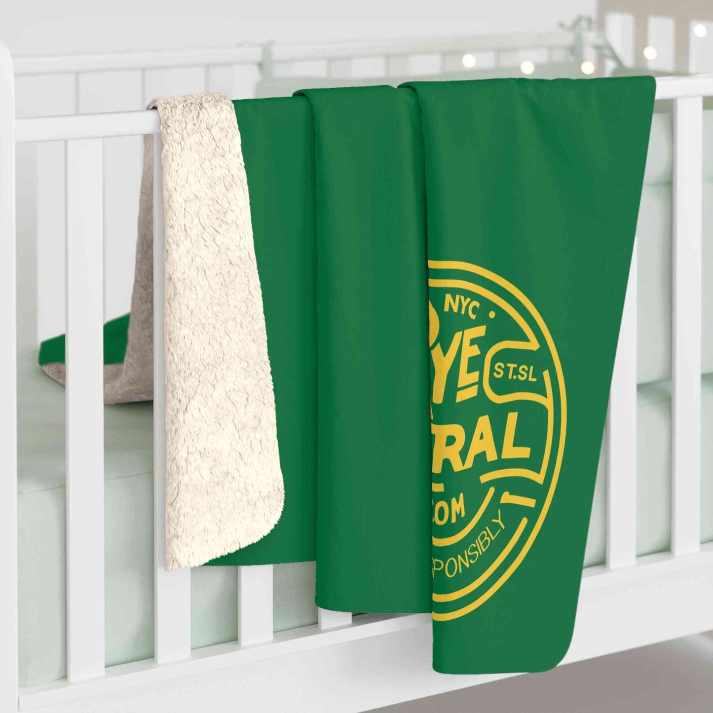 RyeCentral Whiskey Sherpa Fleece Blanket hanging on a crib rail, highlighting its plush sherpa texture and whiskey-themed design for stylish comfort.