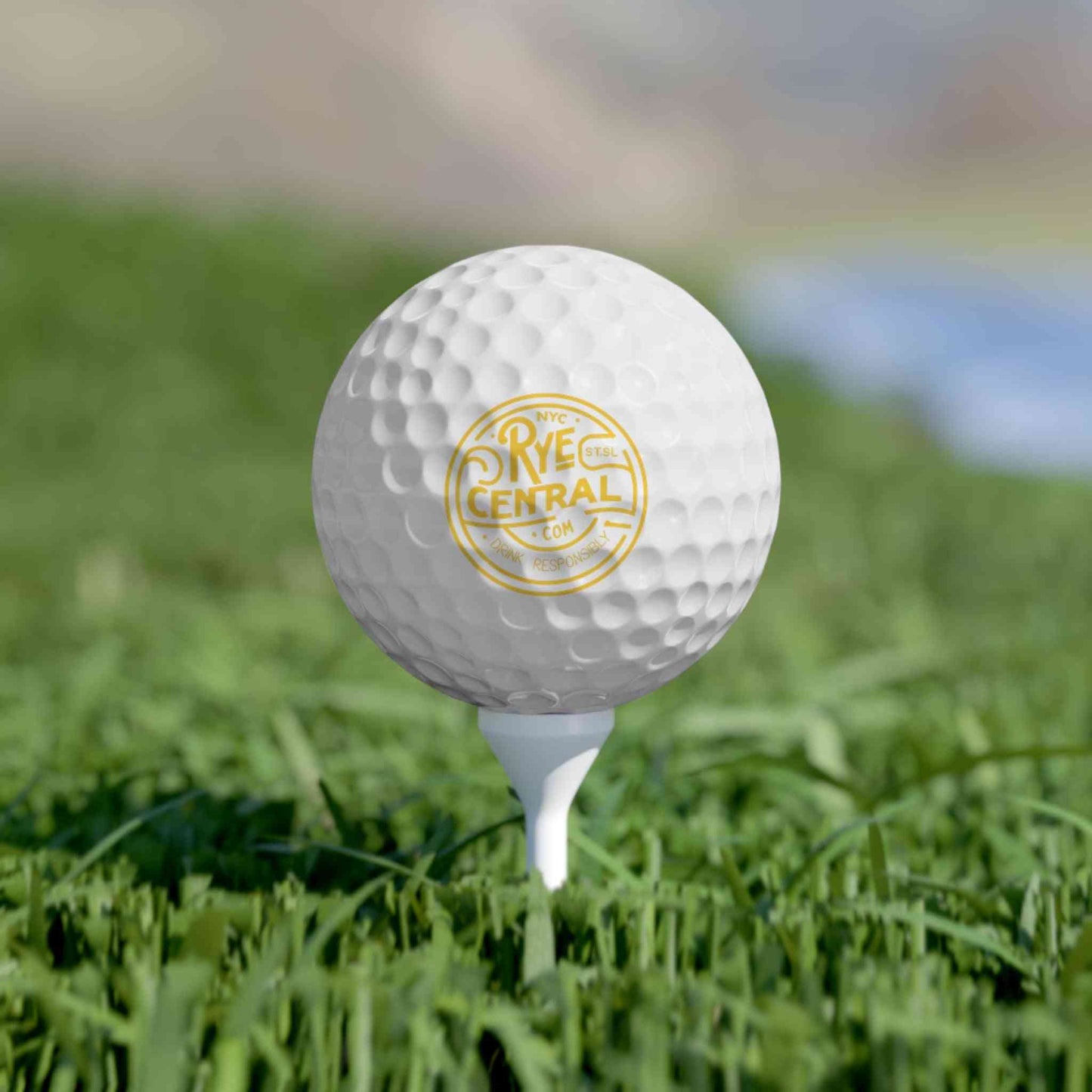 Whiskey Golf Ball with RyeCentral logo placed on a tee, combining fun and function for outdoor sports and novelty golf accessories.