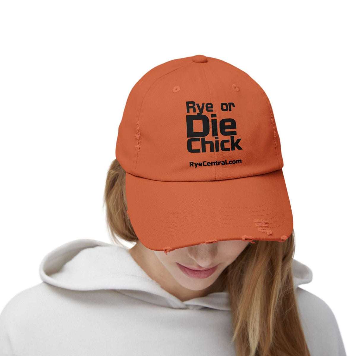 Front view of Rye Whiskey Distressed Cap: Rye or Die Chick worn by a woman, featuring bold black text and distressed cotton design.