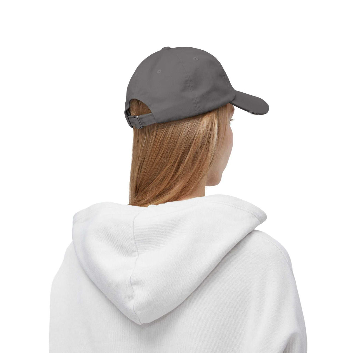 Side-back view of gray unisex distressed whiskey cap on model, highlighting adjustable strap and casual cotton fabric.