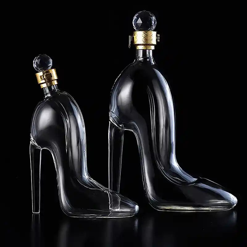 Set of two luxurious glass whiskey decanters shaped like high heel shoes with crystal stoppers, ideal for decorative and functional barware.