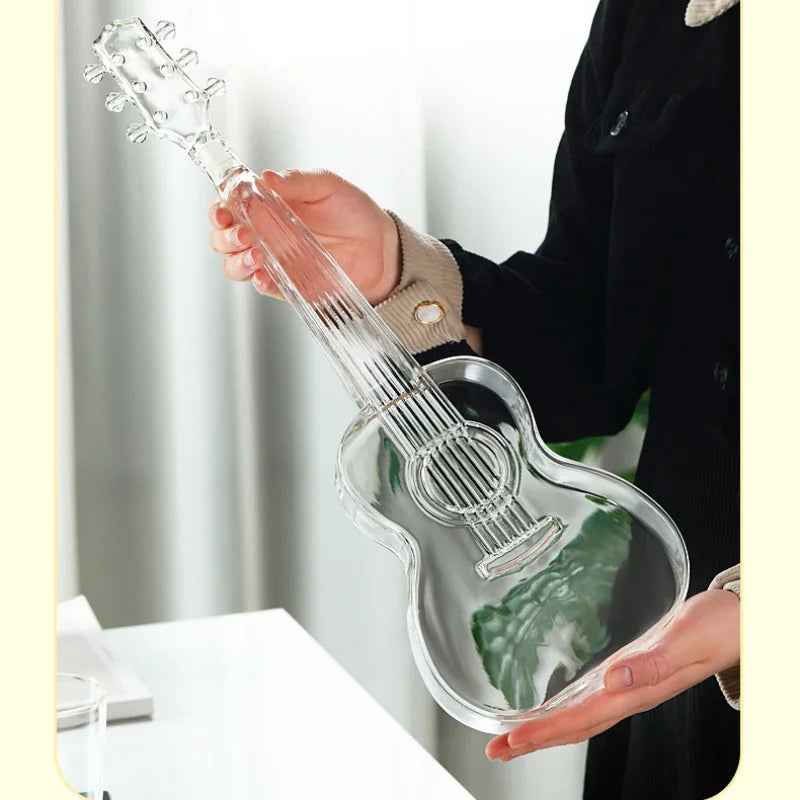 Close-up of empty Guitar Decanter by RyeCentral held in hand, made from high borosilicate glass with detailed string design.