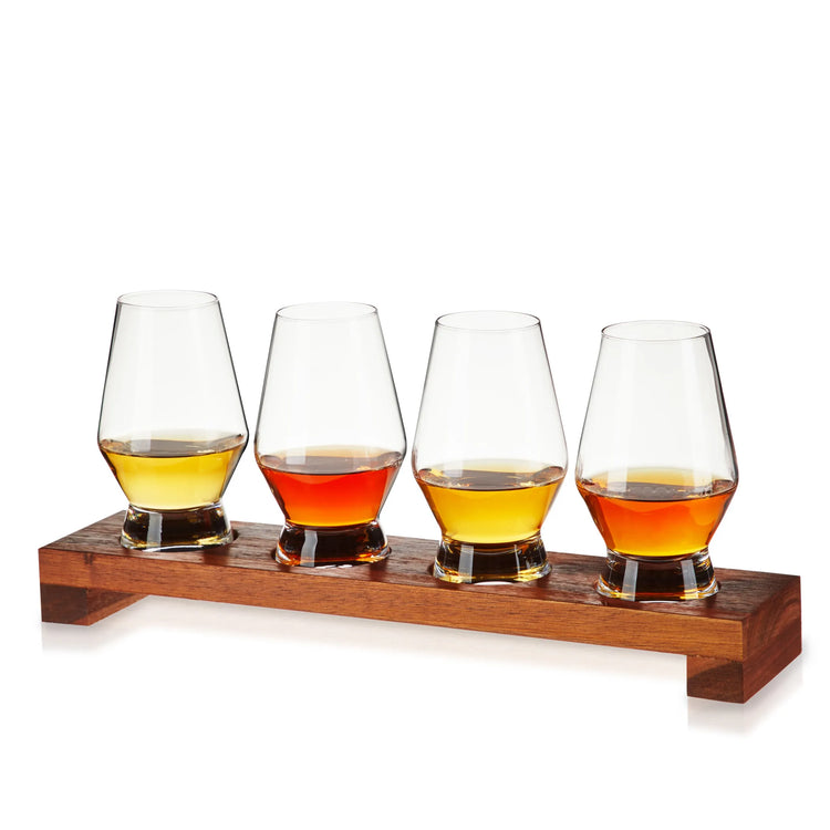 Elegant whiskey tasting glasses set on a wooden flight board.