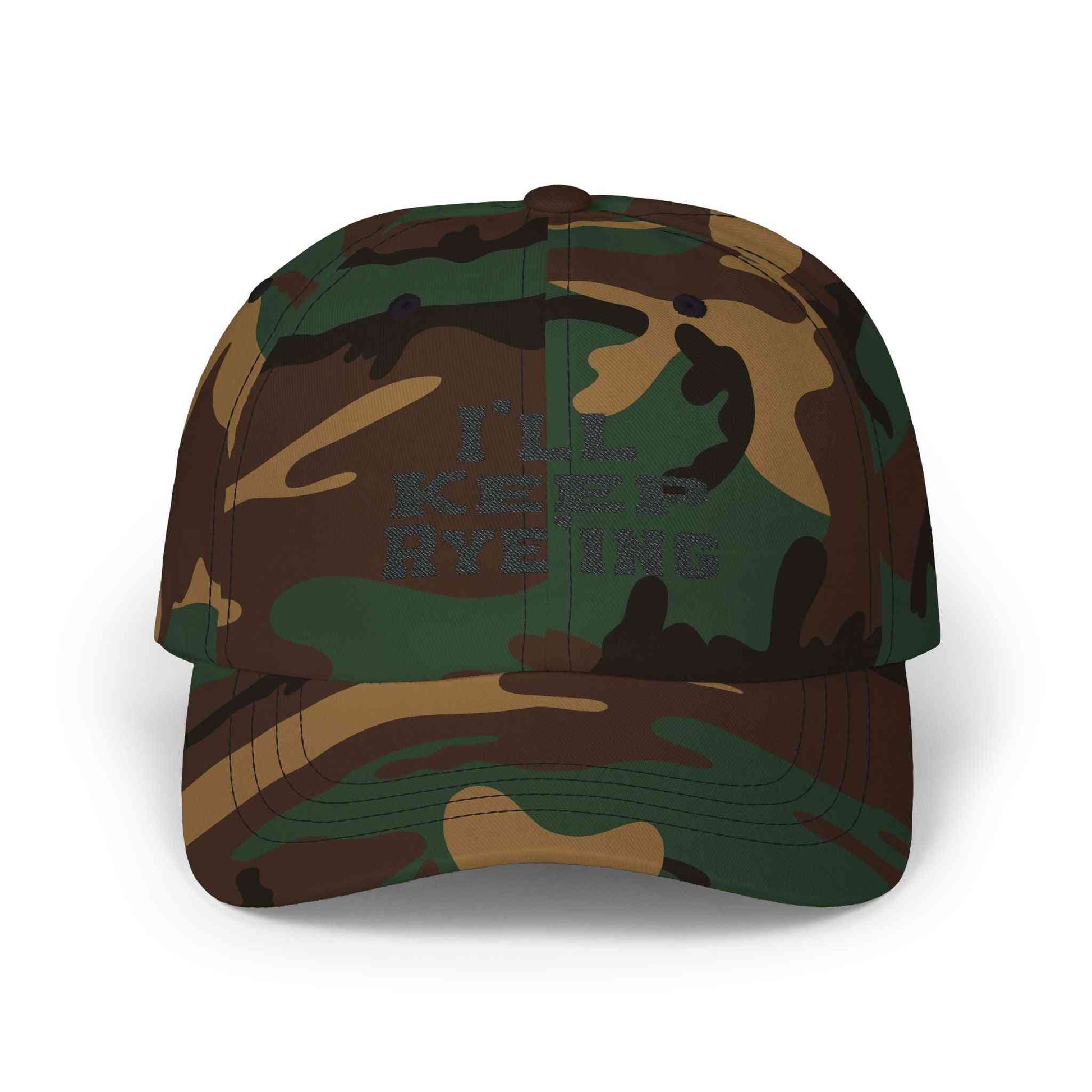 Camo Golf Dad Cap with dark 'I’ll Keep Rye’ing' embroidery, a bold whiskey accessory for outdoor and hunting style lovers.