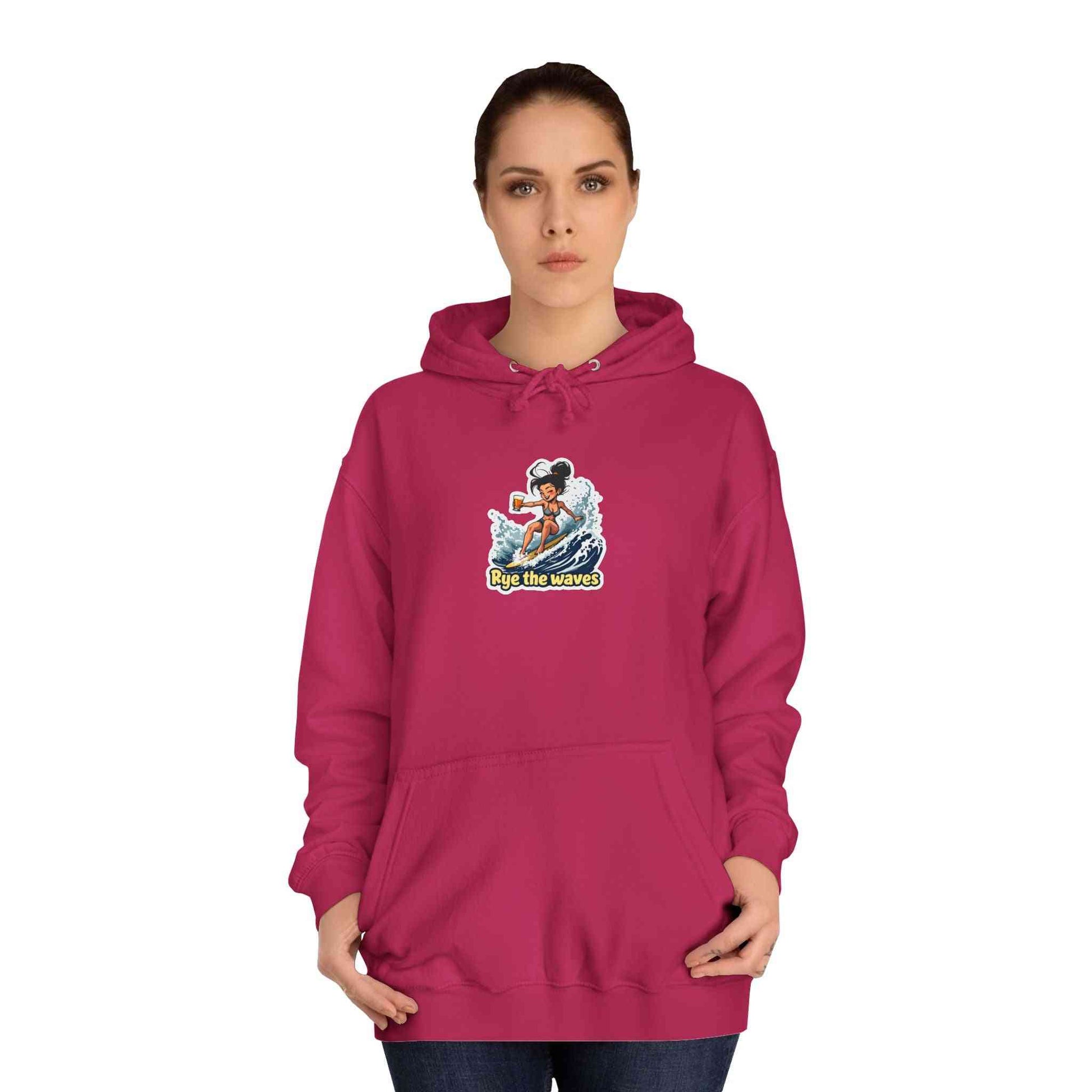 Unisex Rye Whiskey Surf Hoodie in berry pink featuring a surfer graphic and 'Rye the Waves' text, ideal for cozy beach style and ethical fashion.