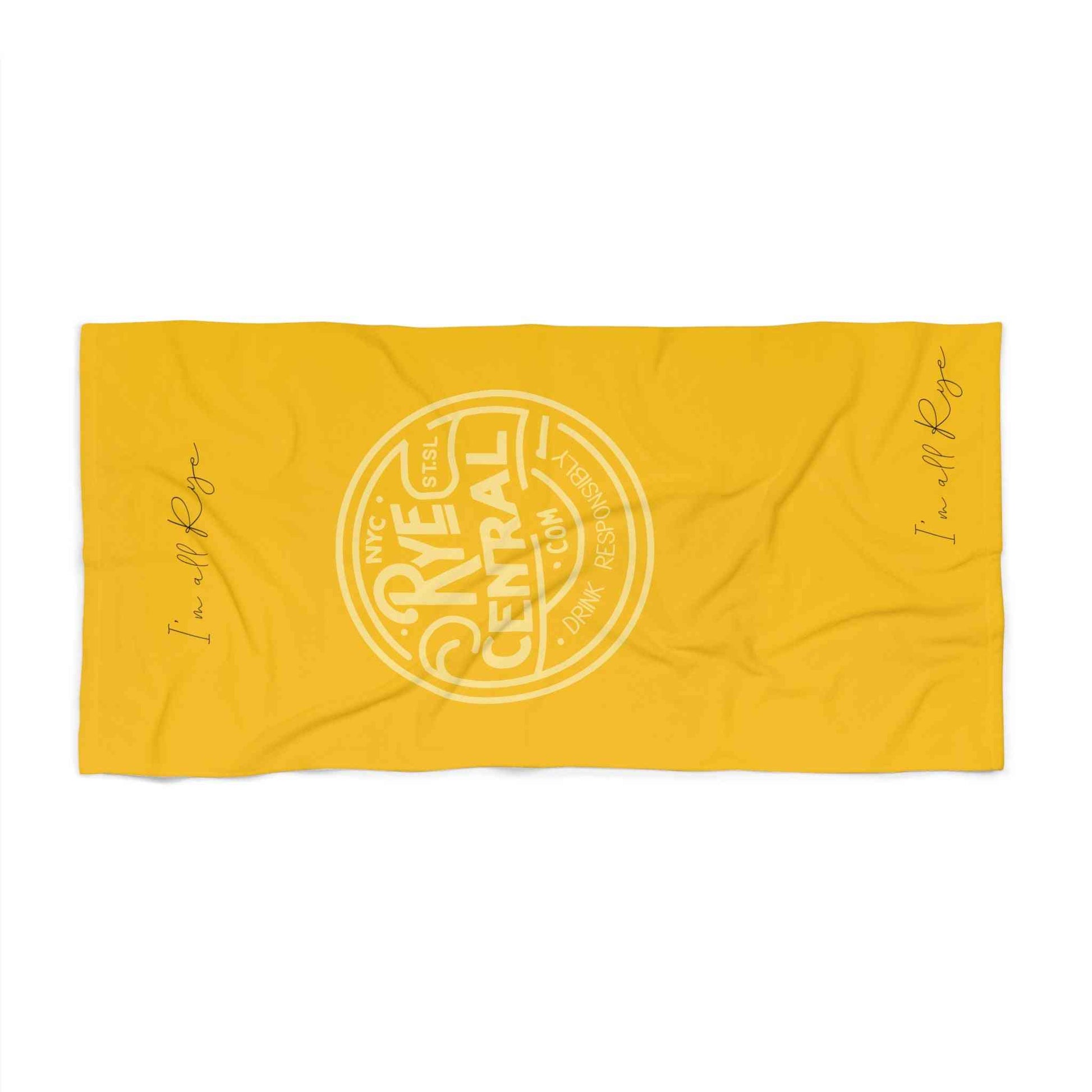 Flat lay of Rye Whiskey Beach Towel Fun and Style in vibrant yellow with RyeCentral.com logo and 'I'm all Rye' text on both ends.