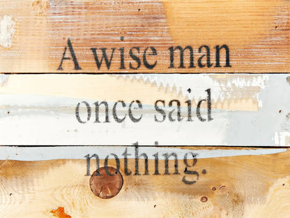 Eco-friendly wall décor sign featuring 'A wise man once said nothing' on multitone reclaimed wood. Handmade accent for rustic interiors.