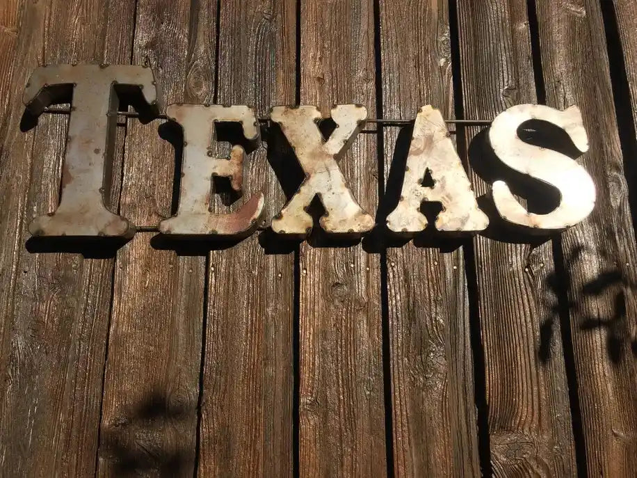 Rustic wall décor spelling TEXAS in recycled metal letters, perfect for home & garden accent décor with a vintage Western aesthetic.