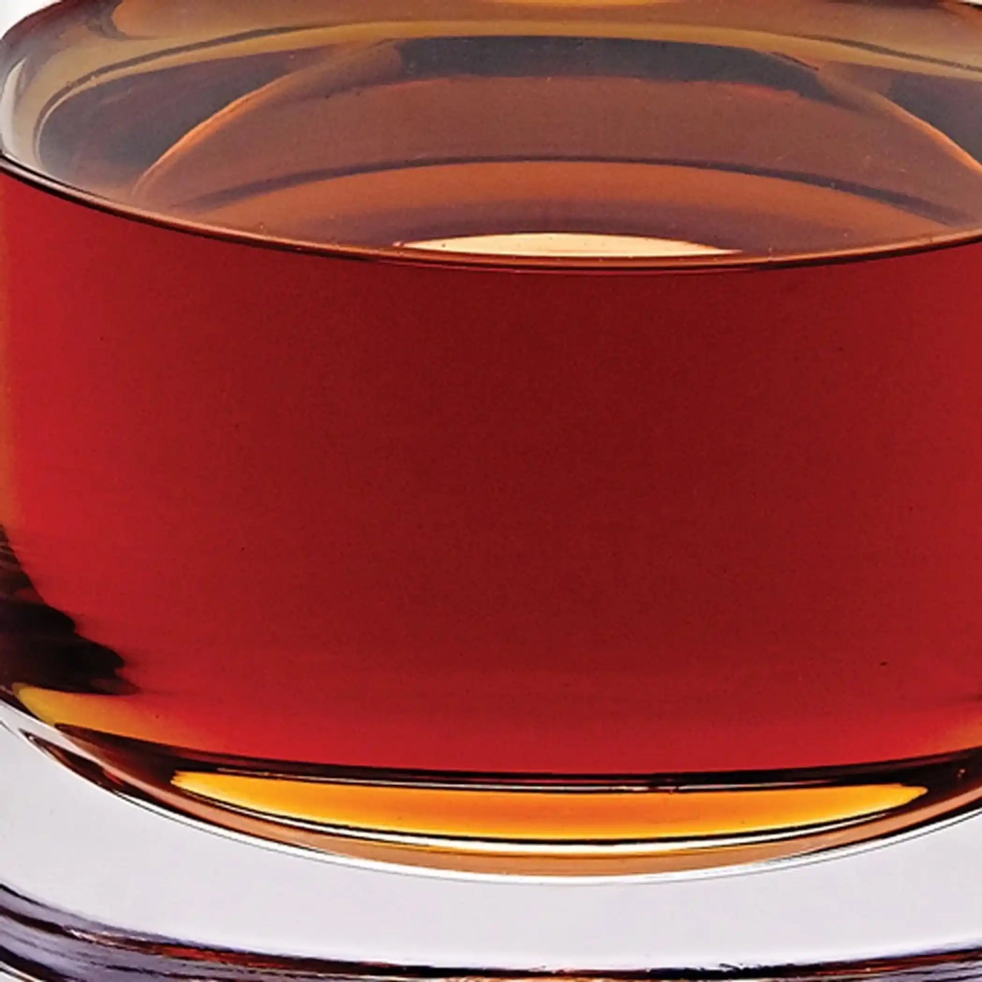 Zoomed-in section of Mouth Blown European Crystal Decanter 28 Oz showing amber tones and crystal clarity. Elegant addition to drinkware sets.