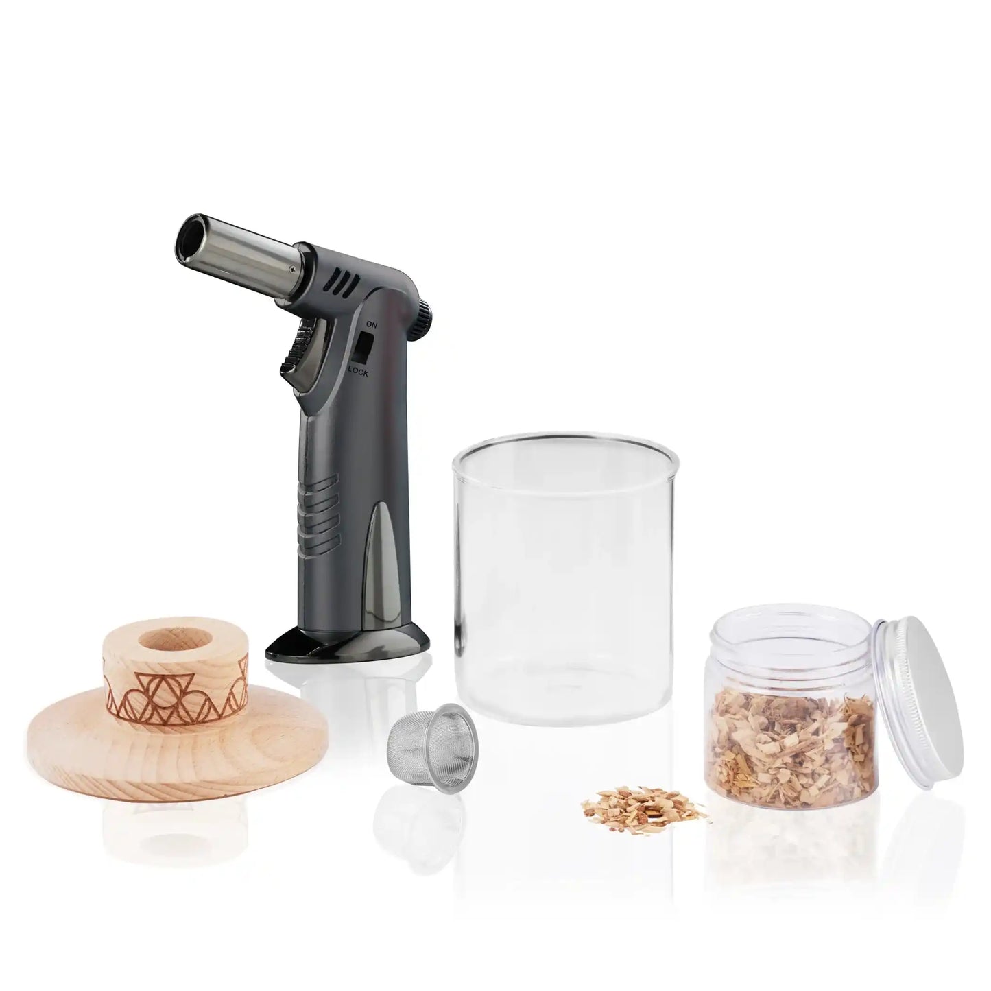 Alchemi Single Serve Smoker Kit in use with torch igniting wood chips to infuse cocktail with smoke. Perfect for enhancing drink presentation and flavor.