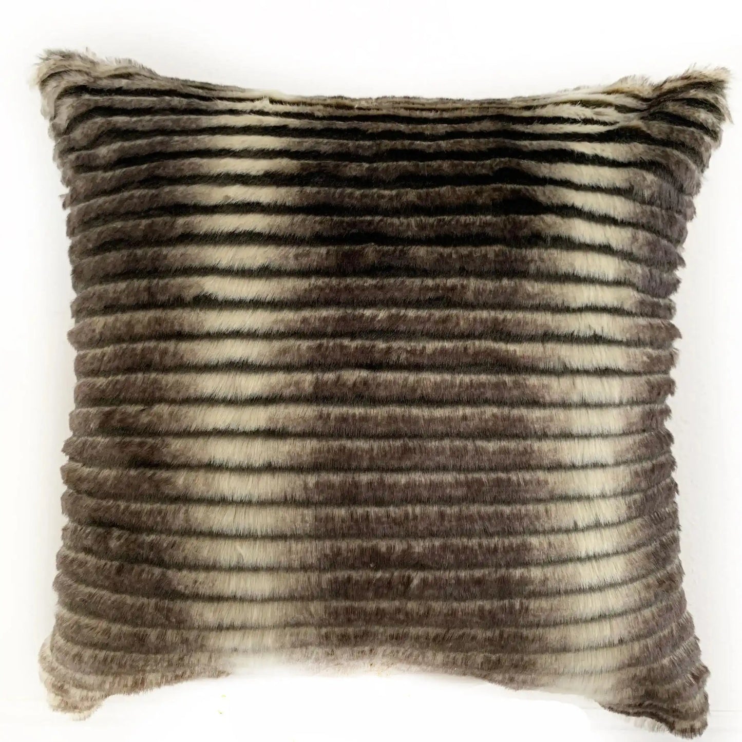 Luxurious Plutus faux fur throw pillow in grey and taupe tones, displayed on a black sofa, perfect for modern living room styling.