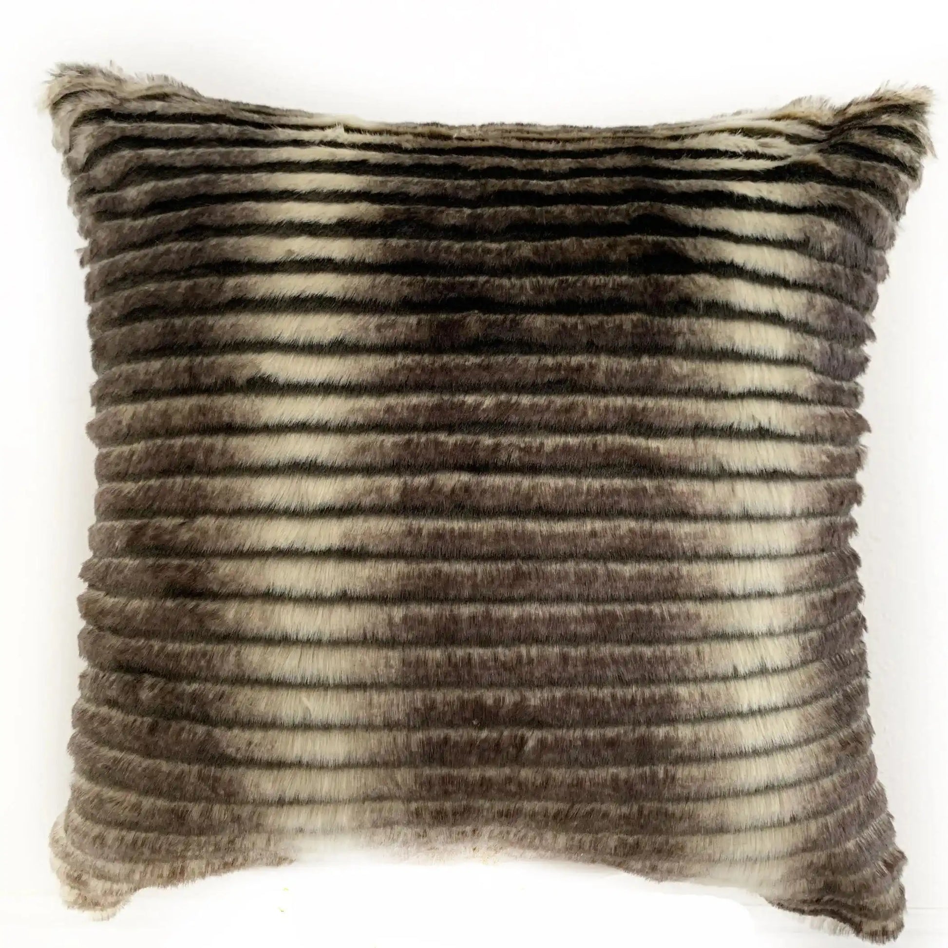 Luxurious Plutus faux fur throw pillow in grey and taupe tones, displayed on a black sofa, perfect for modern living room styling.