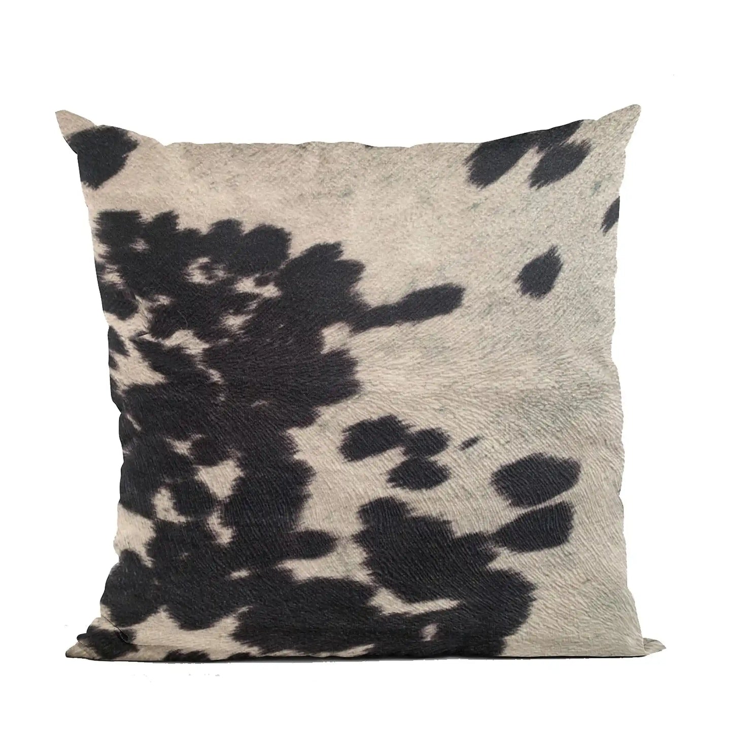 Woman holding luxury cowhide throw pillow with rustic black and white design, ideal for cozy whiskey-inspired interiors.