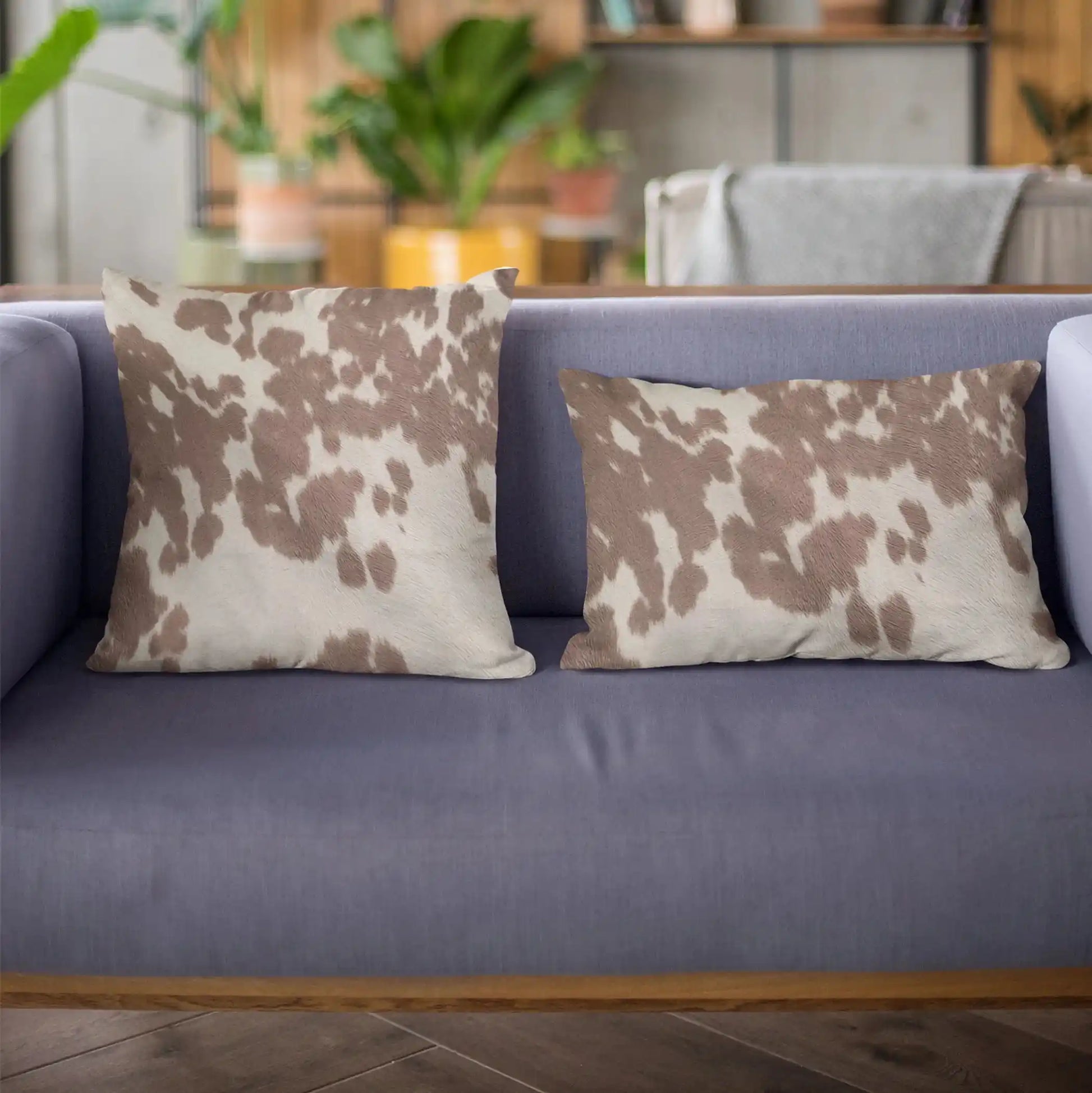 Close-up of premium cowhide throw pillow texture, highlighting natural brown and white pattern ideal for whiskey-inspired interiors.