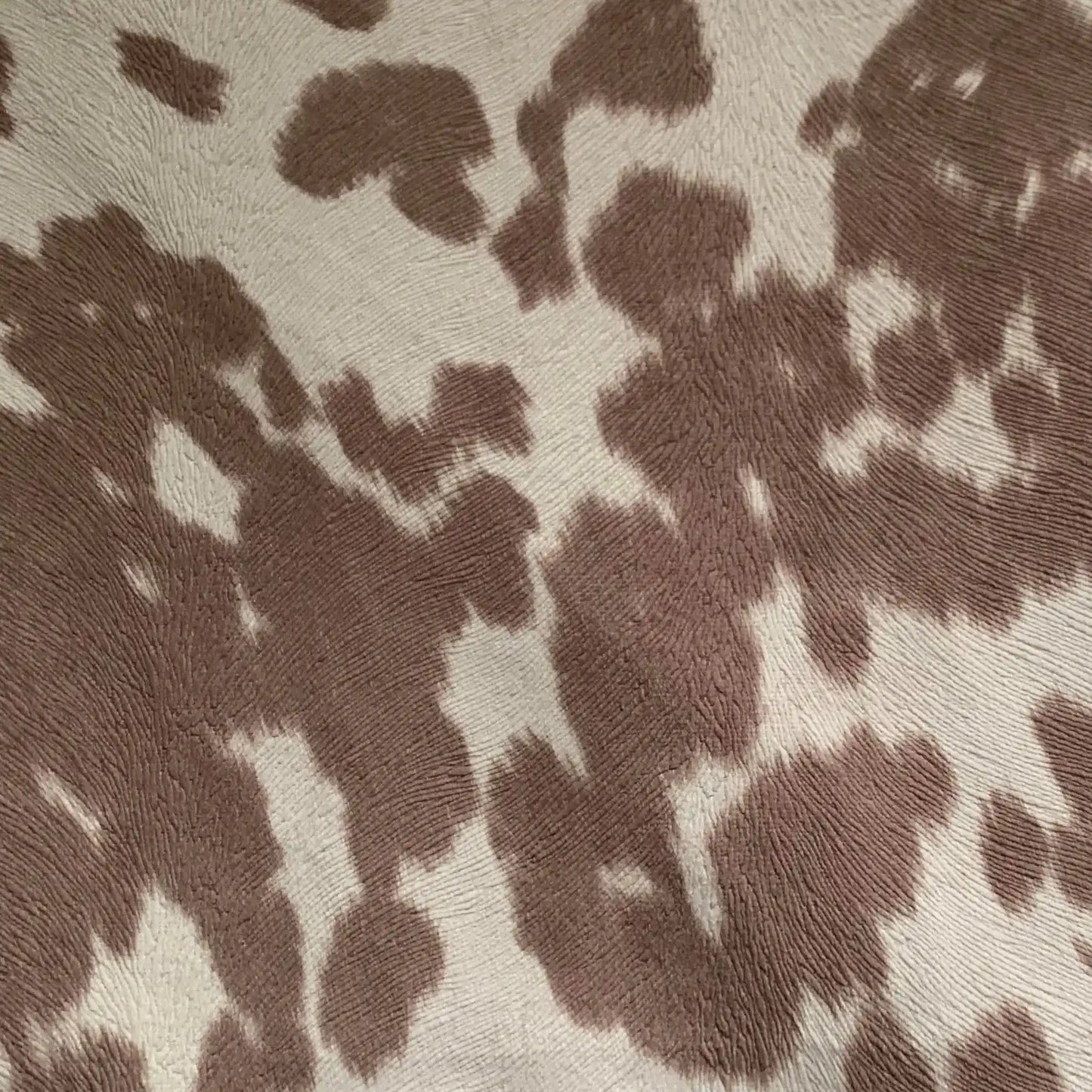 Rectangular premium cowhide throw pillow with brown and white spotted design, perfect for whiskey-themed home accents.