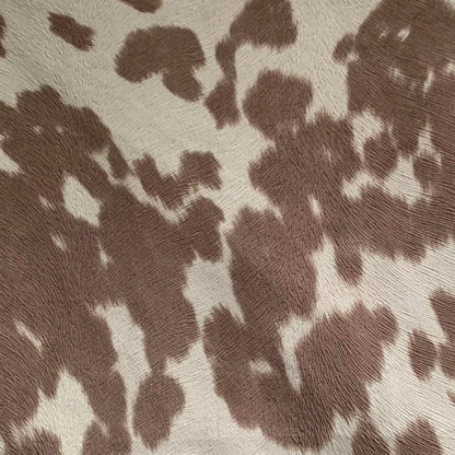 Rectangular premium cowhide throw pillow with brown and white spotted design, perfect for whiskey-themed home accents.