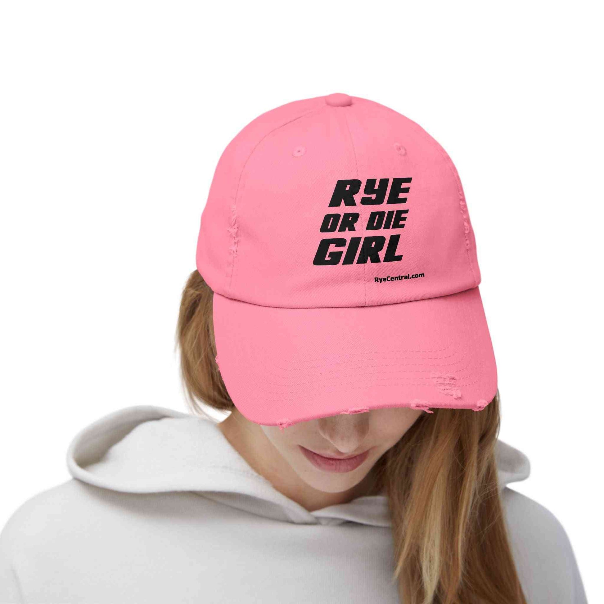 Pink distressed whiskey hat worn by woman, featuring bold 'Rye Or Die Girl' slogan for whiskey fans and summer style.