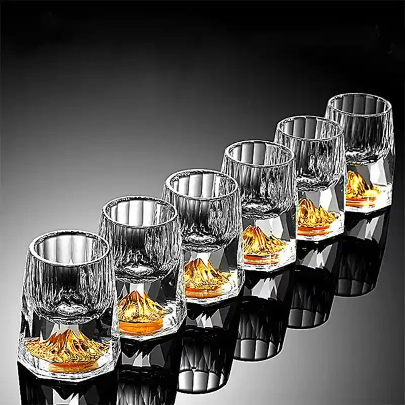 Set of six crystal glass wine glasses with gold foil mountain design, ideal for whiskey, vodka, and cocktail drinks in luxury bar settings.