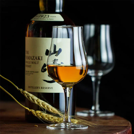 Japanese Whisky Nosing Glass with whisky bottle and barley, showcasing craftsmanship and style for refined whiskey tasting experiences.