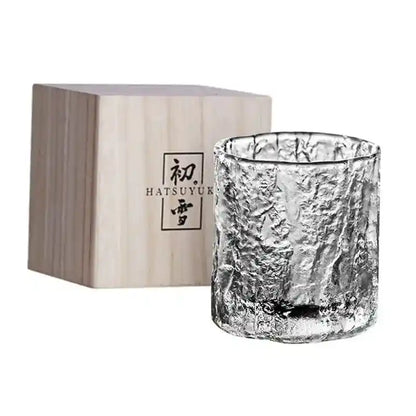 Frosted whiskey tumbler with Nordic Japanese crystal design next to branded wooden box, ideal for luxury drinkware presentation.