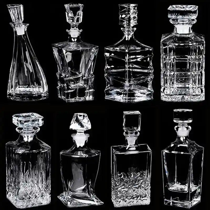 Collection of 8 empty crystal glass liquor pourers in modern and classic styles, perfect for whiskey, wine, and vodka display.