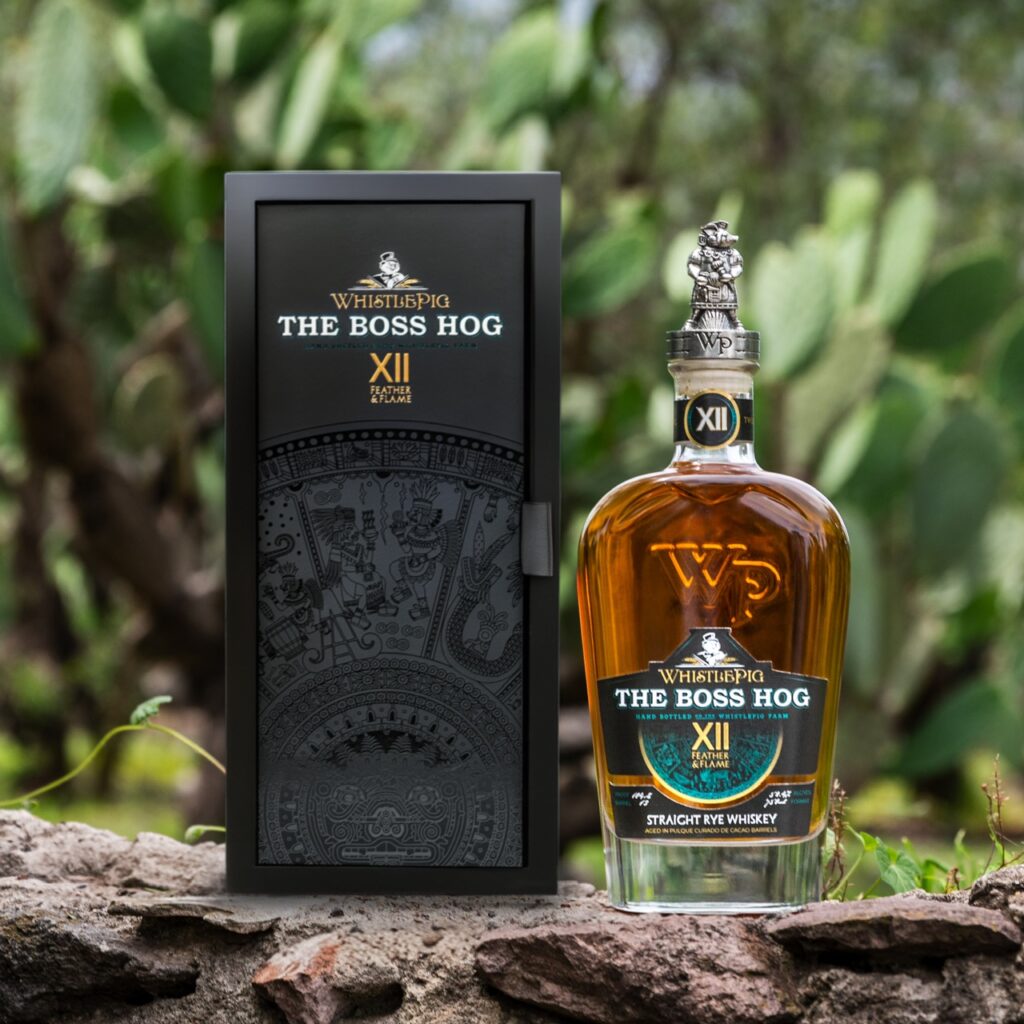 WhistlePig Boss Hog XII Feather and Flame Rye whiskey bottle with packaging in outdoor setting