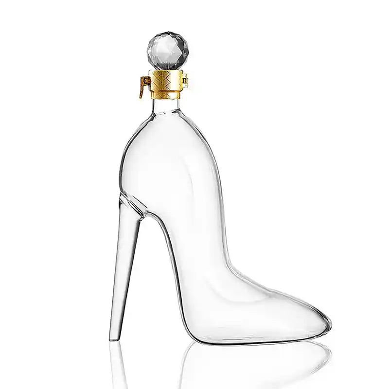 Clear glass whiskey decanter in the shape of a high heel shoe with a crystal stopper, perfect for unique barware collections and gifting.