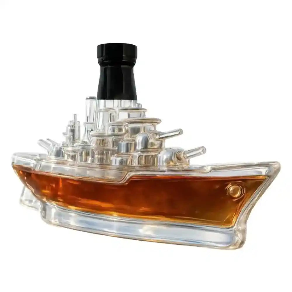 Battleship-shaped glass decanter filled with whiskey, combining maritime design with elegant barware functionality.