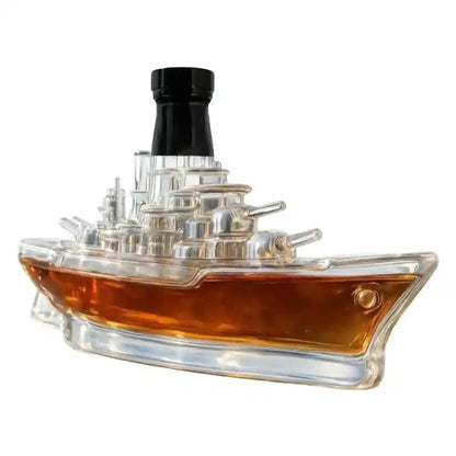 Battleship-shaped glass decanter filled with whiskey, combining maritime design with elegant barware functionality.