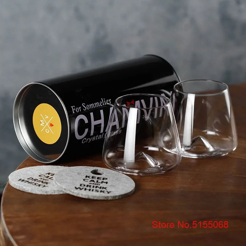 Set of whiskey glasses with whiskey bottle and coaster
