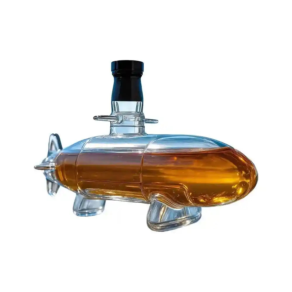 Submarine-shaped glass decanter with amber liquid, a nautical-themed whiskey server for unique home bar aesthetics.