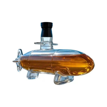 Submarine-shaped glass decanter with amber liquid, a nautical-themed whiskey server for unique home bar aesthetics.
