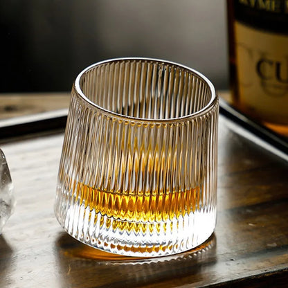Elegant textured whisky glass on wooden surface