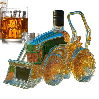3D tractor shaped wine bottle with whiskey inside, designed as a glass decanter for men and women whiskey lovers, placed beside a whiskey glass.
