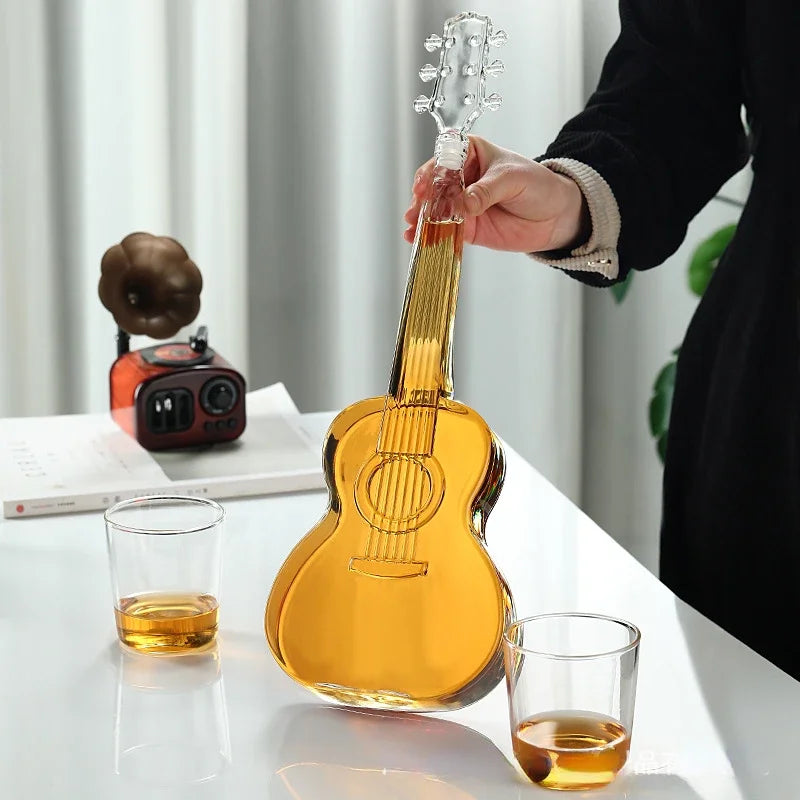 Hand holding guitar decanter, whiskey pouring, stylish barware