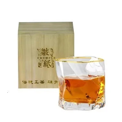 Single Japanese crumple paper whiskey glass with gold rim and wooden box, ideal for elegant whiskey enjoyment.