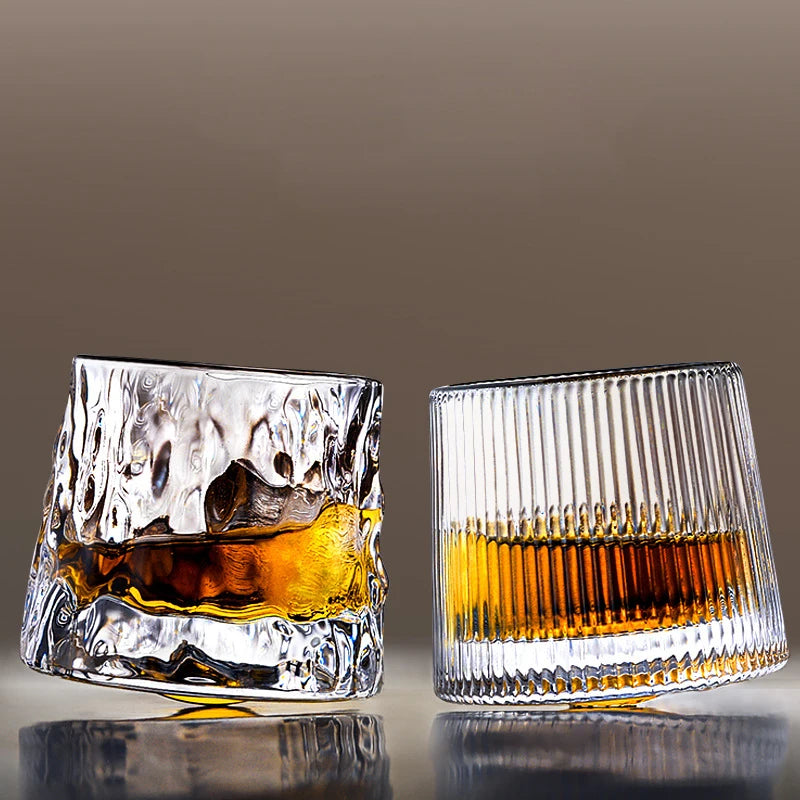 Hand holding textured whisky glass with amber beverage