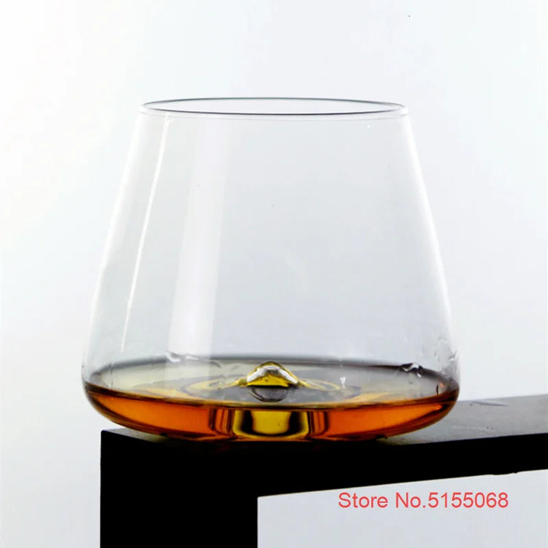 Whiskey glass with whiskey on white background