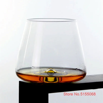 Whiskey glass with whiskey on white background