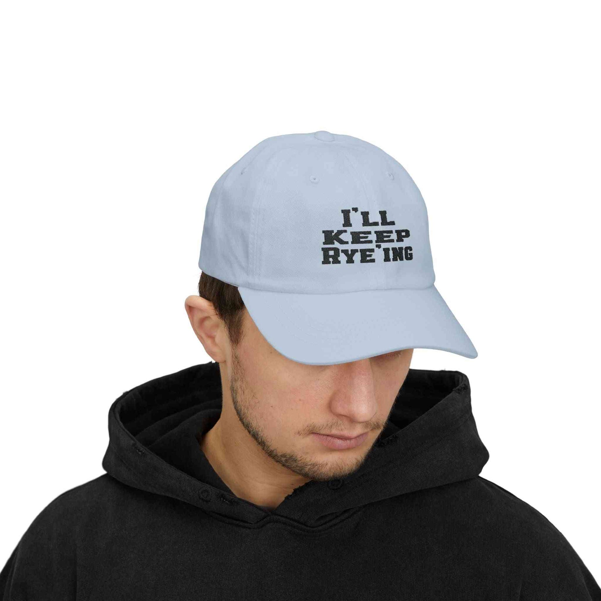 Light blue Golf Dad Cap worn by a model, featuring bold 'I’ll Keep Rye’ing' embroidery for whiskey lovers and golf fans.