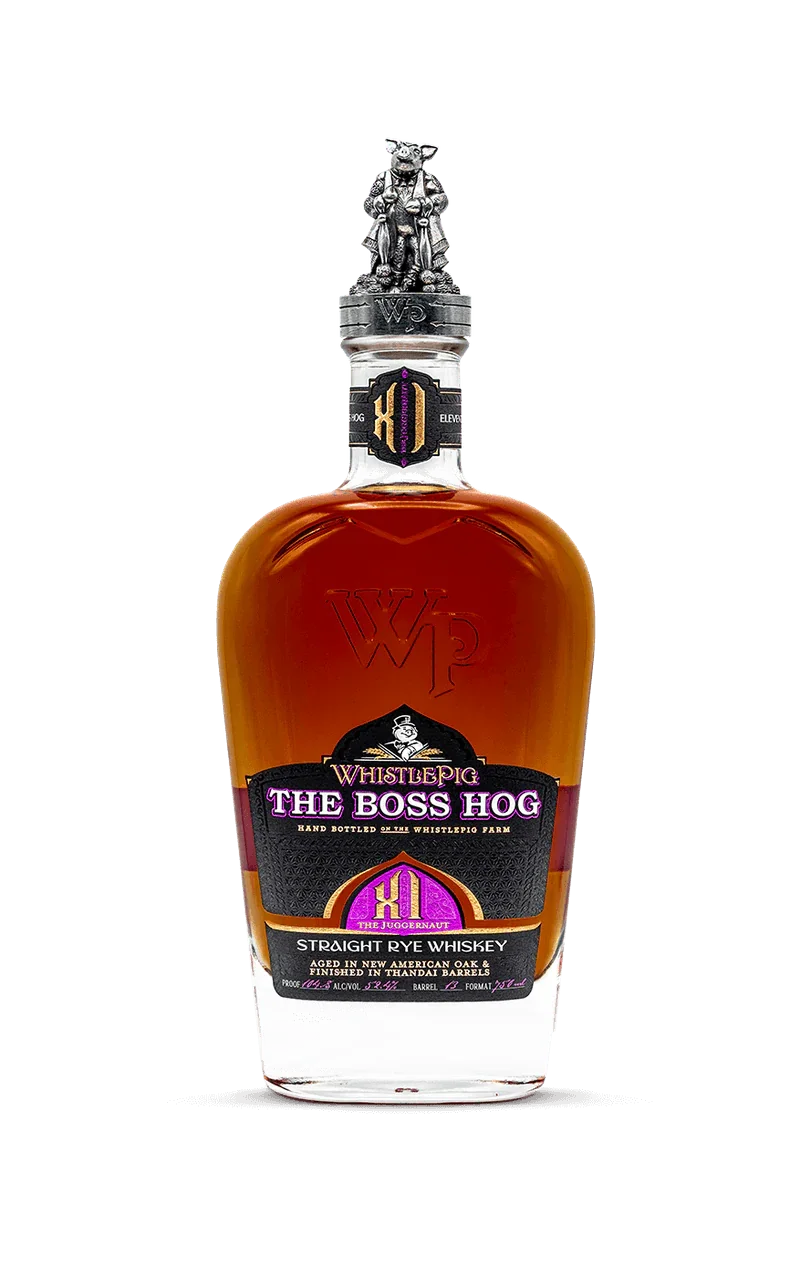 WhistlePig Boss Hog XI The Juggernaut Rye whiskey bottle with a silver pig figurine on top, black and purple label, and amber liquid inside